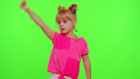 Cheerful-funny-teen-school-girl-kid-dancing,-filming-video-using-mobile-phone-at-home-on-chroma-key