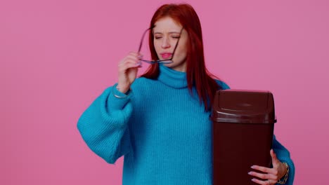 Happy-redhead-teen-girl-in-blue-sweater-taking-off,-throwing-out-glasses-after-vision-treatment