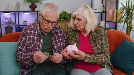 Sad-poor-senior-grandparents-man-woman-counting-money-from-piggybank,-poverty-debt-financial-problem