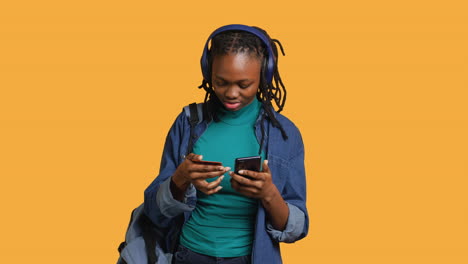 Girl-wearing-headphones-adding-payment-method-on-website,-studio-background