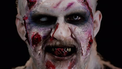 Zombie-Mann-Mit-Wunden,-Narben-Und-Kontaktlinsen,-Der-In-Die-Kamera-Blickt,-Klickt-Mit-Den-Zähnen-Und-Versucht,-Angst-Zu-Machen