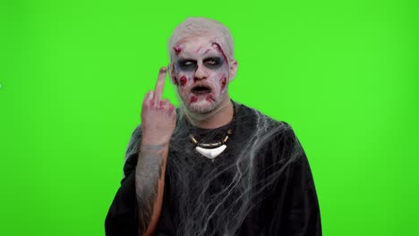 Aggressive-Halloween-zombie-man-showing-around-middle-fingers,-demonstrating-protest-rude-gesture