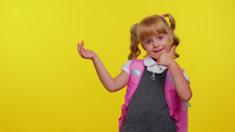 School-girl-kid-in-uniform-showing-thumbs-up,-pointing-left-at-copy-space-for-promotional-content