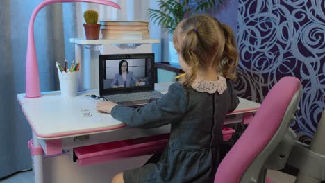 Preschool-child-girl-distance-online-education-at-home,-pupil-watching-video-lessons-on-laptop