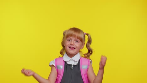 Smiling-school-girl-showing-thumbs-up-and-pointing-empty-place,-advertising-area-for-commercial-text