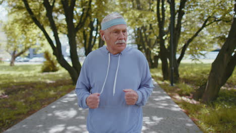 Athletic-senior-sport-jogger-man-grandfather-training-running,-celebrating-finish-success-race-win