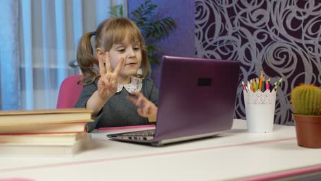Child-girl-pupil-schoolgirl-learns-lessons-with-teacher-being-at-home-using-digital-laptop-computer