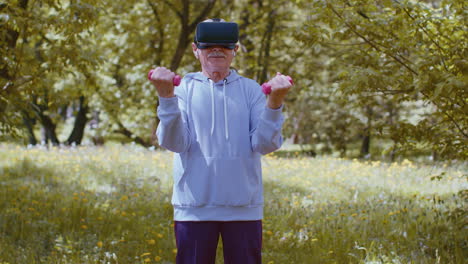 Senior-man-exercising,-making-dumbbell-weight-lifting-exercises,-wearing-VR-helmet-play-video-game