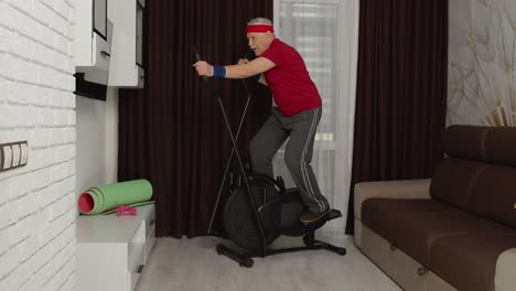 Senior-man-using-orbitrek-with-fitness-exercises-in-living-room-at-home-during-coronavirus-lockdown