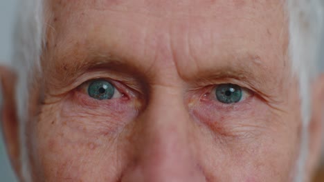 Extreme-close-up-macro-portrait-of-wrinkled-face,-old-senior-beautiful-man's-eyes-looking-at-camera
