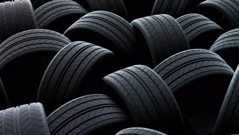 Endless-chaotic-stack-of-new-tires.-Close-up-camera-moves-above-them-in-a-loop.-Infinite-stack-of-rubber-tires-used-for-automotive-wheels.-Modern-massive-scale-manufacturing-of-consumer-goods.