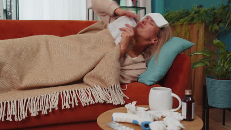 Sick-ill-woman-suffering-from-cold-or-allergy-lying-on-home-sofa-sneezes-wipes-snot-into-napkin