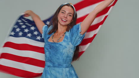 Lovely-young-woman-waving-and-wrapping-in-American-USA-flag,-celebrating,-human-rights-and-freedoms