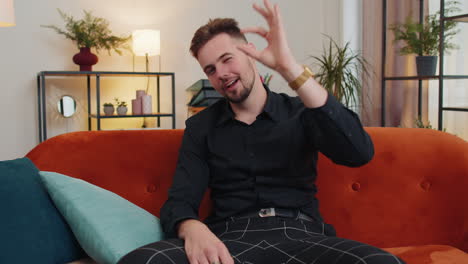 Happy-cheerful-young-adult-man-looking-approvingly-at-camera-showing-ok-gesture,-positive-like-sign