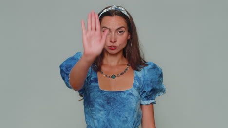 Girl-say-No-hold-palm-folded-crossed-hands-in-stop-gesture,-warning-of-finish,-prohibited-access