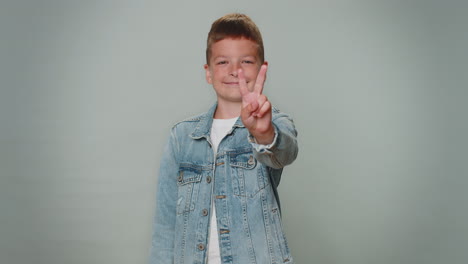 Toddler-lovely-boy-showing-victory-sign,-hoping-for-success-and-win,-doing-peace-gesture,-smiling