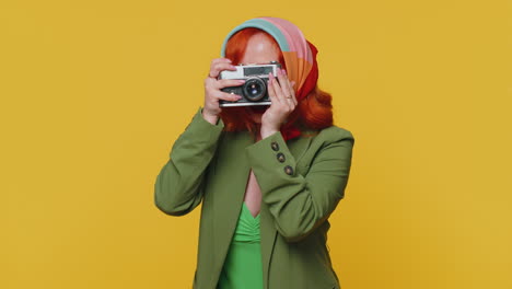 Redhead-young-woman-tourist-photographer-taking-photos-on-retro-camera-and-smiling,-holiday-vacation