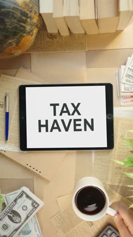 VERTICAL-VIDEO-OF-TAX-HAVEN-DISPLAYING-ON-FINANCE-TABLET-SCREEN