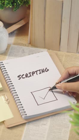 VERTICAL-VIDEO-OF-TICKING-OFF-SCRIPTING-WORK-FROM-CHECKLIST