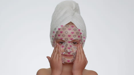 Child-girl-applying-cosmetic-moisturizing-face-mask,-teenager-skin-care-treatment,-natural-cosmetics