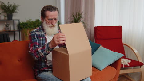 Angry-dissatisfied-shopper-senior-old-man-unpacking-parcel-feeling-upset,-confused,-wrong-delivery