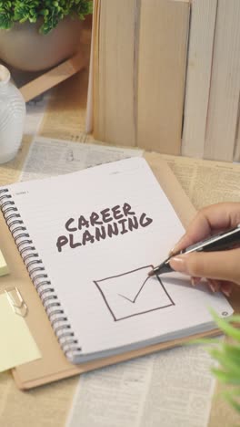 VERTICAL-VIDEO-OF-TICKING-OFF-CAREER-PLANNING-WORK-FROM-CHECKLIST