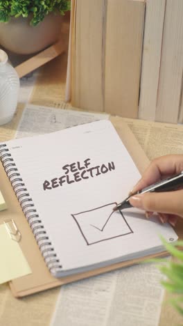 VERTICAL-VIDEO-OF-TICKING-OFF-SELF-REFLECTION-WORK-FROM-CHECKLIST