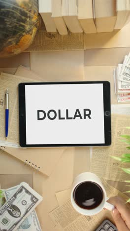 VERTICAL-VIDEO-OF-DOLLAR-DISPLAYING-ON-FINANCE-TABLET-SCREEN