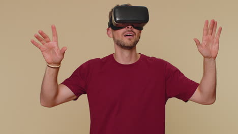 Young-man-using-headset-helmet-app-to-play-simulation-drawing-game-watching-virtual-reality-3D-video