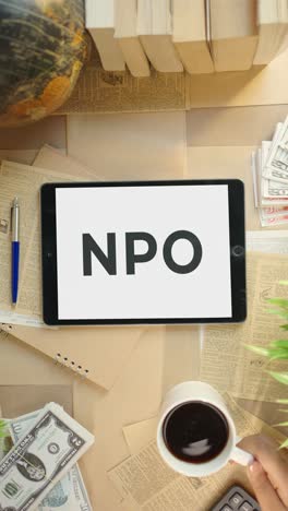 VERTICAL-VIDEO-OF-NPO-DISPLAYING-ON-FINANCE-TABLET-SCREEN