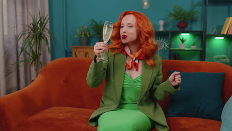 Joyful-redhead-girl-drinking-champagne-celebrate-success-win,-career-grow-up,-purchase-of-new-home