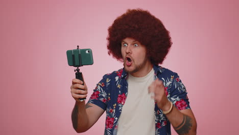Man-blogger-take-selfie-on-mobile-phone-selfie-stick-communicate-video-call-online-with-subscribers