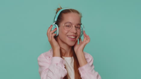 Happy-pretty-relaxed-girl-listening-music-on-headphones-and-dancing-disco-fooling-around-having-fun