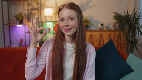 Happy-cheerful-child-girl-kid-looking-approvingly-at-camera-showing-ok-gesture,-positive-like-sign