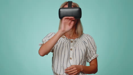 Woman-using-virtual-reality-futuristic-technology-VR-headset-helmet-to-play-simulation-3D-video-game