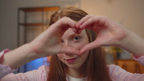 Teen-child-girl-kid-makes-symbol-of-love,-showing-heart-sign-to-camera,-express-romantic-feelings