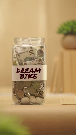 VERTICAL-VIDEO-OF-PERSON-SAVING-MONEY-FOR-DREAM-BIKE