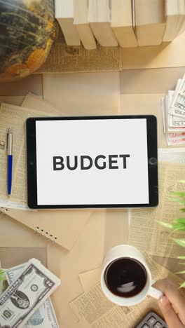 VERTICAL-VIDEO-OF-BUDGET-DISPLAYING-ON-FINANCE-TABLET-SCREEN