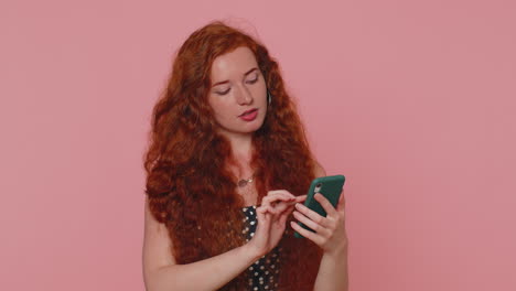Redhead-girl-using-mobile-phone-typing-post-on-web-sms-message-browsing-addiction-of-social-networks