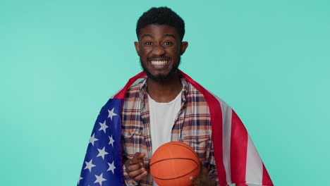 Bearded-young-man-basketball-fan-holding-American-USA-flag-doing-winner-gesture,-dancing-alone