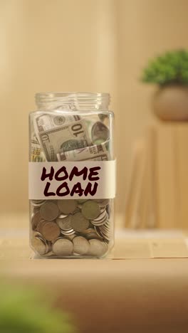 VERTICAL-VIDEO-OF-PERSON-SAVING-MONEY-FOR-HOME-LOAN