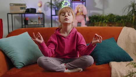 Child-breathes-deeply-eyes-closed-meditating-with-concentrated-thoughts-peaceful,-break-time-resting