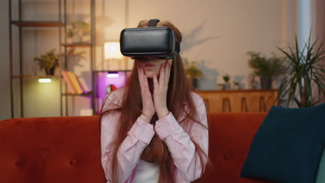 Child-girl-using-virtual-reality-futuristic-technology-headset-play-simulation-3D-video-game-at-home