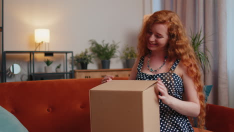 Angry-dissatisfied-shopper-redhead-woman-unpacking-parcel-feeling-upset,-confused,-wrong-delivery