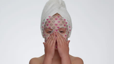 Child-girl-applying-cosmetic-moisturizing-face-mask,-teenager-skin-care-treatment,-natural-cosmetics