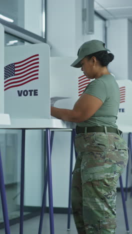 Asian-woman-comes-to-voting-booths-in-polling-station-office.-National-Election-Day-in-United-States.-Political-races-of-US-presidential-candidates.-Concept-of-civic-duty-and-patriotism.-Dolly-shot.
