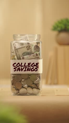 VERTICAL-VIDEO-OF-PERSON-SAVING-MONEY-FOR-COLLEGE-SAVINGS