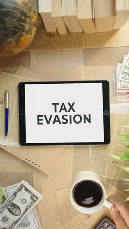 VERTICAL-VIDEO-OF-TAX-EVASION-DISPLAYING-ON-FINANCE-TABLET-SCREEN