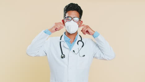 Happy-Indian-doctor-man-removing,-taking-off-medical-protective-mask,-ending-of-flu-pandemic