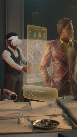 Tailor-and-male-African-American-customer-in-VR-headsets-in-atelier.-3D-hologram-of-suit-pattern.-Virtual-interface-menu-of-software-for-designing-and-modeling-garment.-Vertical-shot